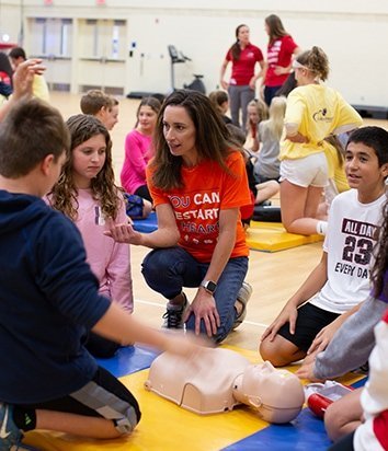 Christy Silva training students on CPR+AED